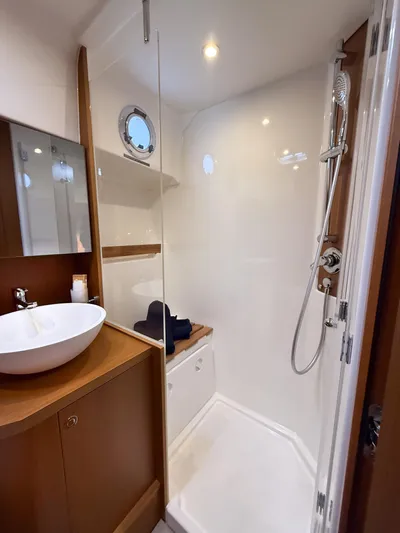 Demo Yacht Photos Pics 2025 Beneteau Swift Trawler 48 bathroom with modern shower and sink.