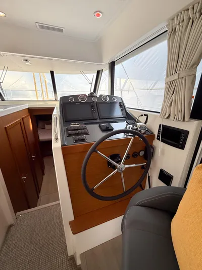 Demo Yacht Photos Pics 2025 Beneteau Swift Trawler 48 helm with modern navigation equipment and comfortable seating.