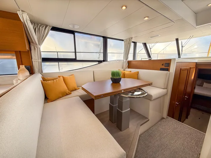 Demo Yacht Photos Pics Interior of 2025 Beneteau Swift Trawler 48 with elegant seating and dining area.