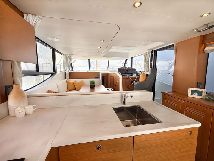 Demo Yacht Photos Pics Interior of 2025 Beneteau Swift Trawler 48, featuring modern kitchen and spacious seating area.