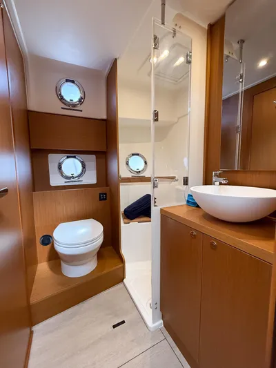 Demo Yacht Photos Pics 2025 Beneteau Swift Trawler 48 bathroom with modern fixtures and wooden cabinetry.