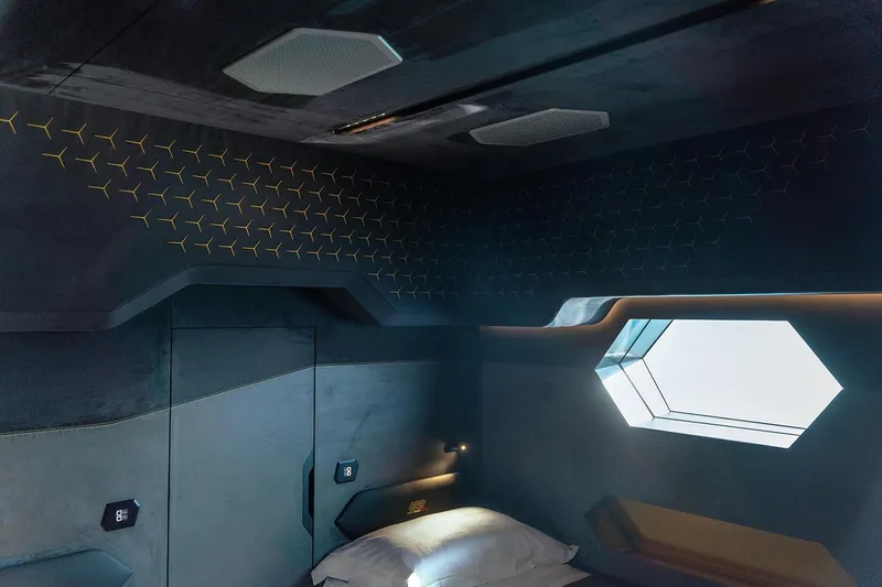  Yacht Photos Pics Futuristic interior of 2026 Tecnomar Lamborghini 63 yacht cabin with geometric window design.