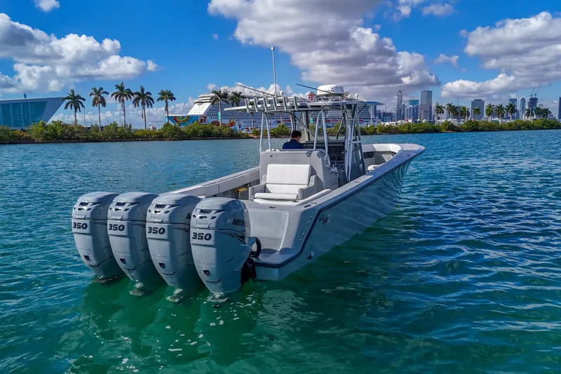  Yacht Photos Pics 2018 SeaVee 390Z boat with four engines on clear water, city skyline in background.