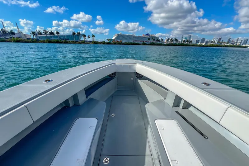  Yacht Photos Pics 2018 SeaVee 390Z boat on water, city skyline and cruise ship in background.