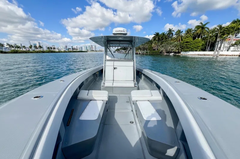  Yacht Photos Pics 2018 SeaVee 390Z boat on calm water, clear sky, city skyline in background.