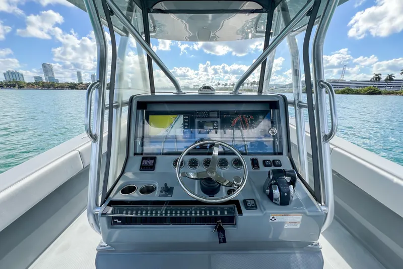  Yacht Photos Pics 2018 SeaVee 390Z boat helm with modern controls and scenic waterfront view.