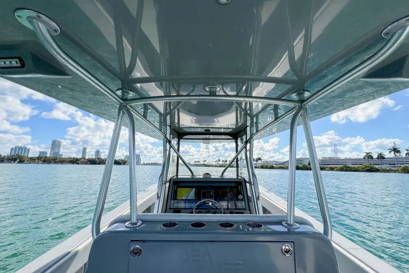  Yacht Photos Pics 2018 SeaVee 390Z boat on water, city skyline in background, sunny day.