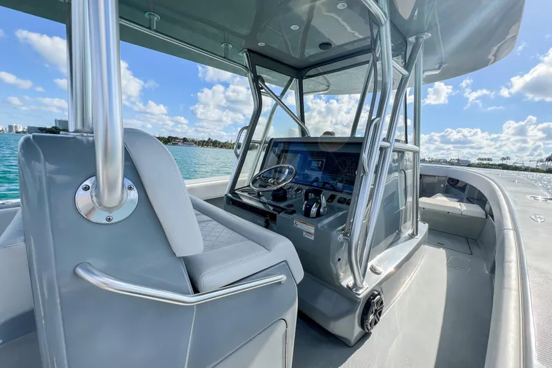  Yacht Photos Pics 2018 SeaVee 390Z boat interior with helm, steering wheel, and ocean view.