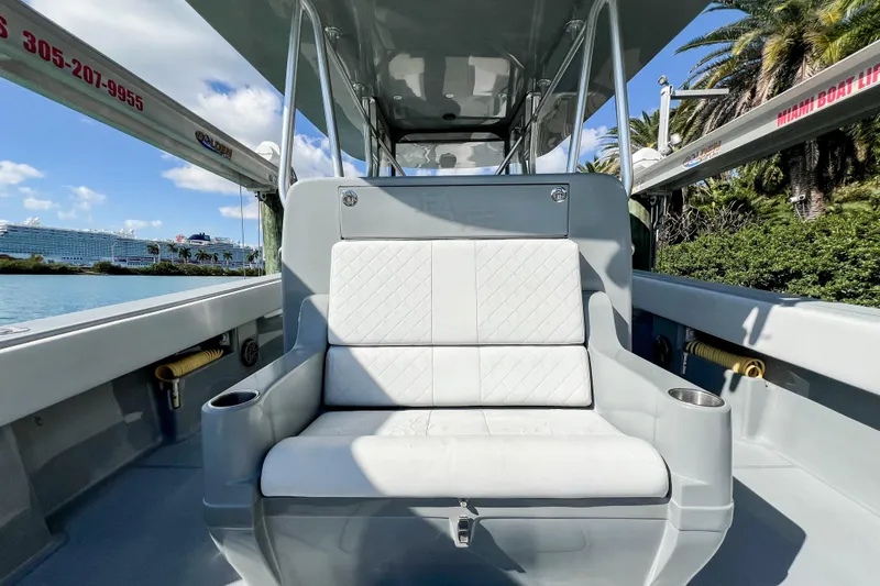  Yacht Photos Pics 2018 SeaVee 390Z boat interior with white seating, cup holders, and scenic waterfront view.