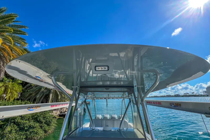  Yacht Photos Pics 2018 SeaVee 390Z boat with T-top, docked under clear blue sky.