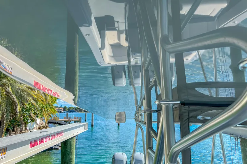  Yacht Photos Pics Upside-down view of a 2018 SeaVee 390Z boat on a lift by the water.