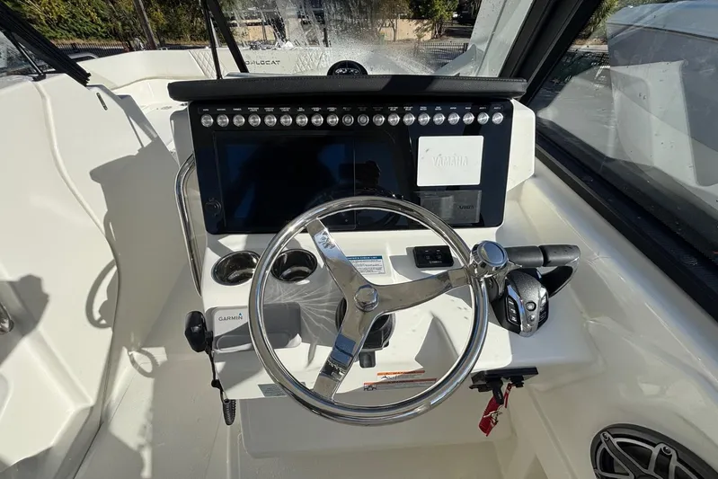  Yacht Photos Pics 2026 World Cat 265 DC-X boat helm with steering wheel and control panel.