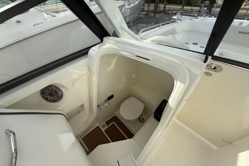  Yacht Photos Pics 2026 World Cat 265 DC-X boat interior with compact marine toilet and speaker.