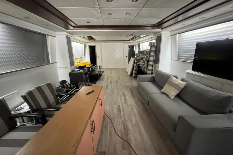 M/y Q Yacht Photos Pics Luxurious interior of a 2001 Falcon 106 yacht with modern furnishings and wood flooring.