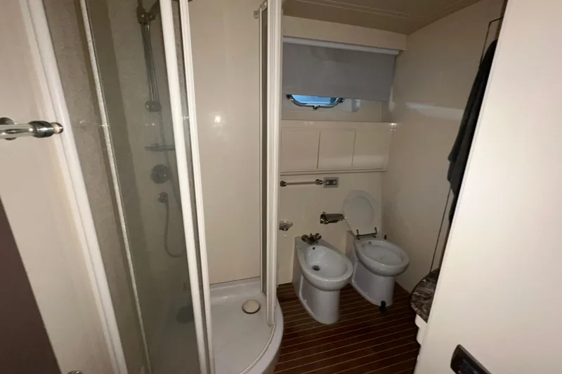 M/y Q Yacht Photos Pics Bathroom with shower, toilet, and bidet in 2001 Falcon 106 yacht.