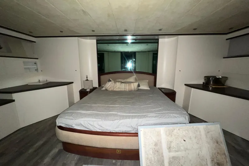 M/y Q Yacht Photos Pics Luxurious bedroom interior of 2001 Falcon 106 yacht with modern furnishings and ambient lighting.