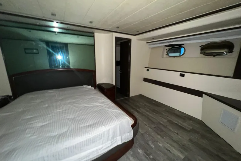 M/y Q Yacht Photos Pics Luxurious bedroom interior of 2001 Falcon 106 yacht with modern design and cozy ambiance.