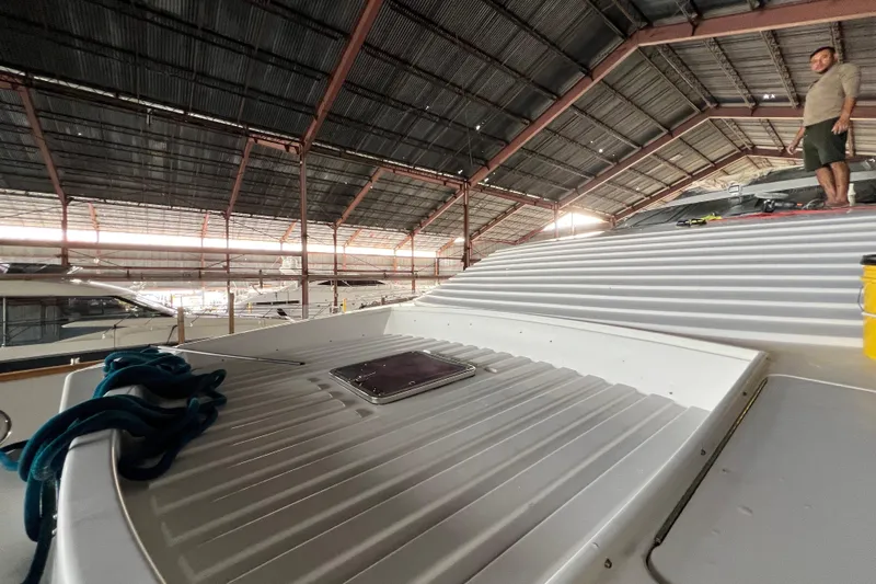 M/y Q Yacht Photos Pics Indoor view of a 2001 Falcon 106 yacht under maintenance in a spacious boatyard.