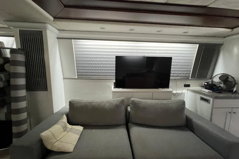 M/y Q Yacht Photos Pics Luxurious interior of a 2001 Falcon 106 yacht with modern decor and entertainment setup.