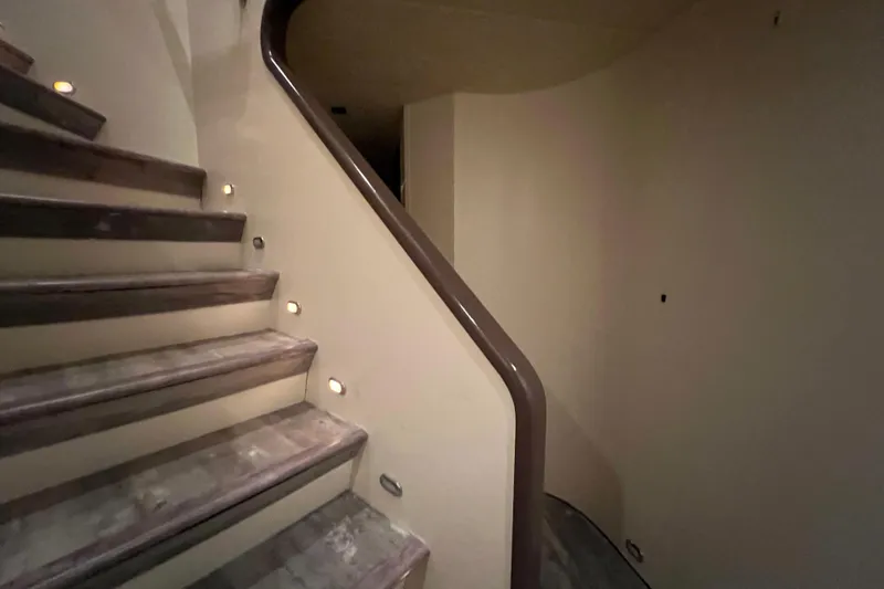 M/y Q Yacht Photos Pics Curved staircase with built-in lights on a Falcon 106 yacht, 2001 model.