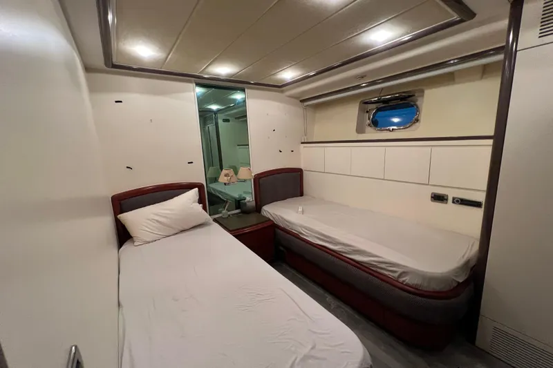 M/y Q Yacht Photos Pics Interior of a 2001 Falcon 106 yacht cabin with twin beds and modern decor.