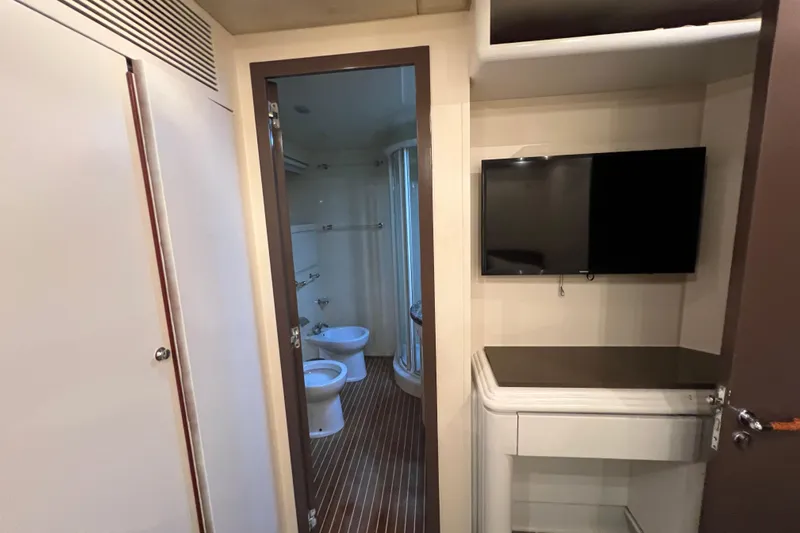 M/y Q Yacht Photos Pics Interior of Falcon 106 yacht, featuring a bathroom and wall-mounted TV, 2001 model.