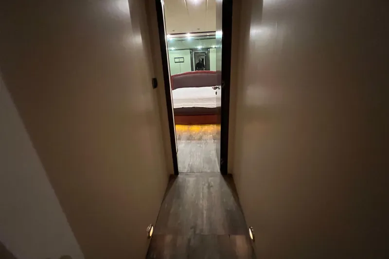 M/y Q Yacht Photos Pics Narrow hallway leading to a bedroom on a 2001 Falcon 106 yacht.