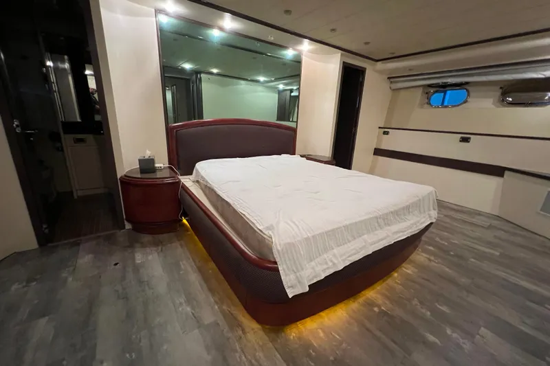 M/y Q Yacht Photos Pics Luxurious bedroom interior on a 2001 Falcon 106 yacht, featuring modern design and ambient lighting.