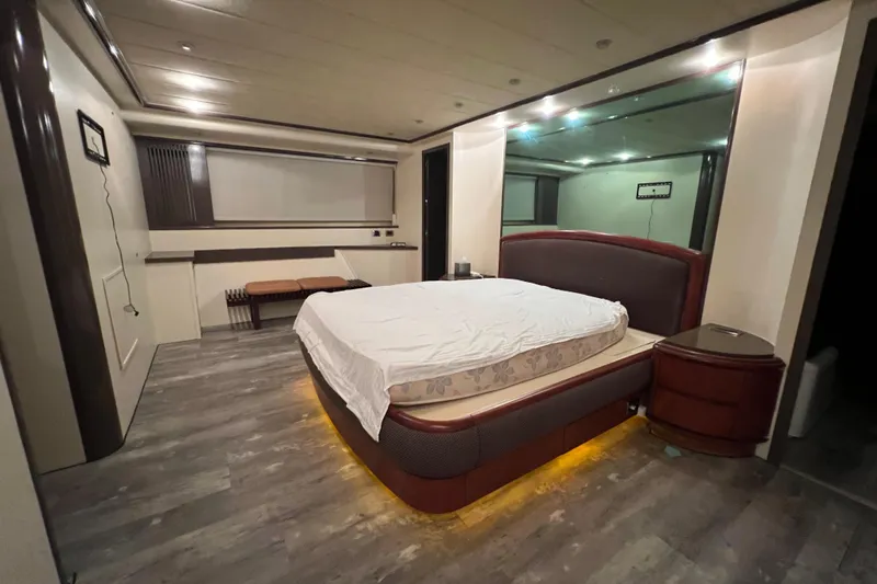 M/y Q Yacht Photos Pics Luxurious bedroom interior on Falcon 106 yacht, 2001 model, featuring modern design and ambient lighting.