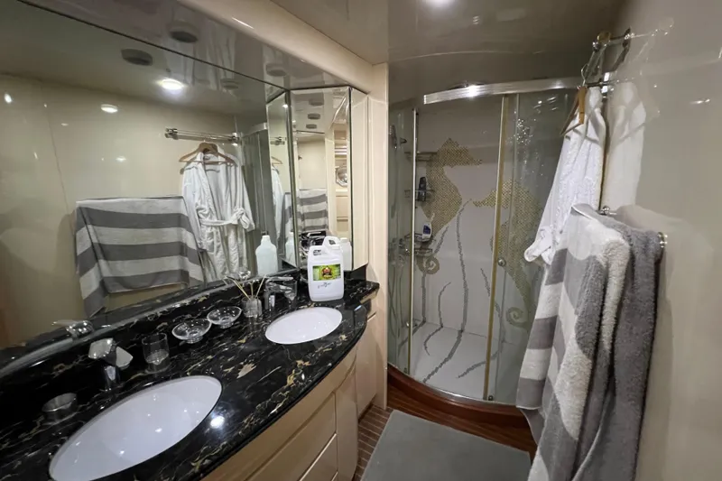 M/y Q Yacht Photos Pics Luxurious yacht bathroom with double sinks, glass shower, and elegant decor, Falcon 106, 2001 model.