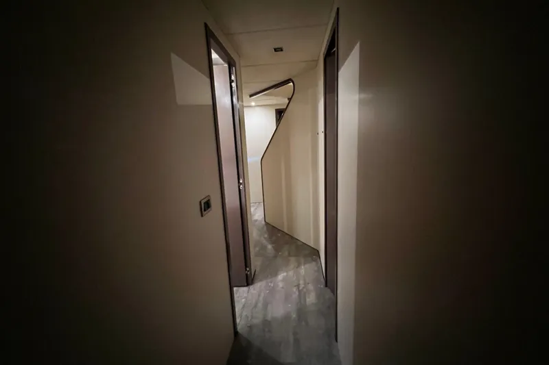 M/y Q Yacht Photos Pics Narrow hallway inside a 2001 Falcon 106 yacht, featuring modern design and lighting.