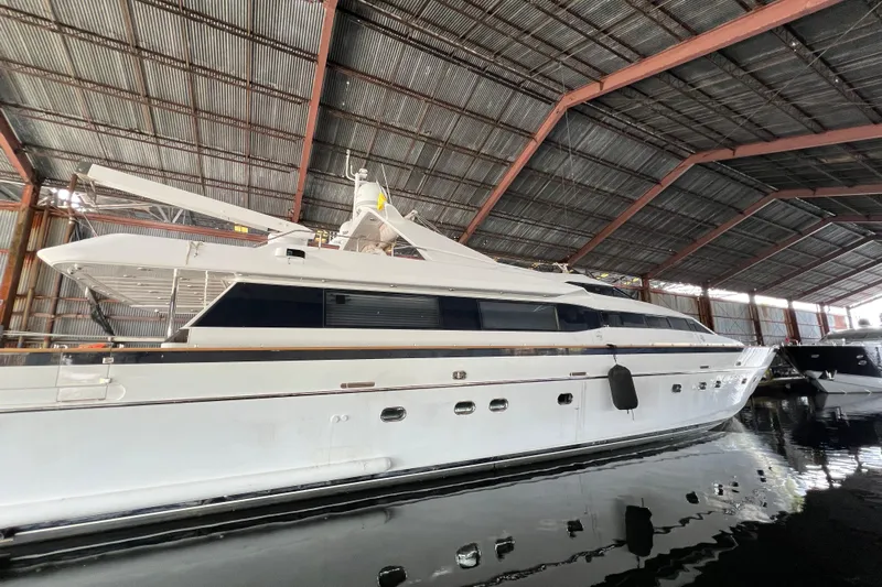 M/y Q Yacht Photos Pics Luxury Falcon 106 yacht from 2001 docked in a spacious marina.