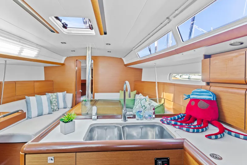 Deep Blue Yacht Photos Pics Interior of 2020 Jeanneau Sun Odyssey 389 yacht with modern kitchen and seating area.
