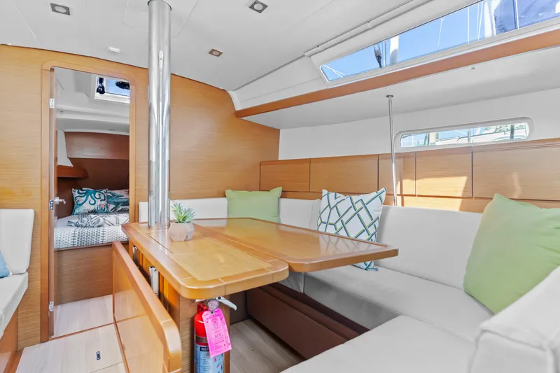 Deep Blue Yacht Photos Pics Interior of 2020 Jeanneau Sun Odyssey 389 sailboat with cozy seating and dining area.