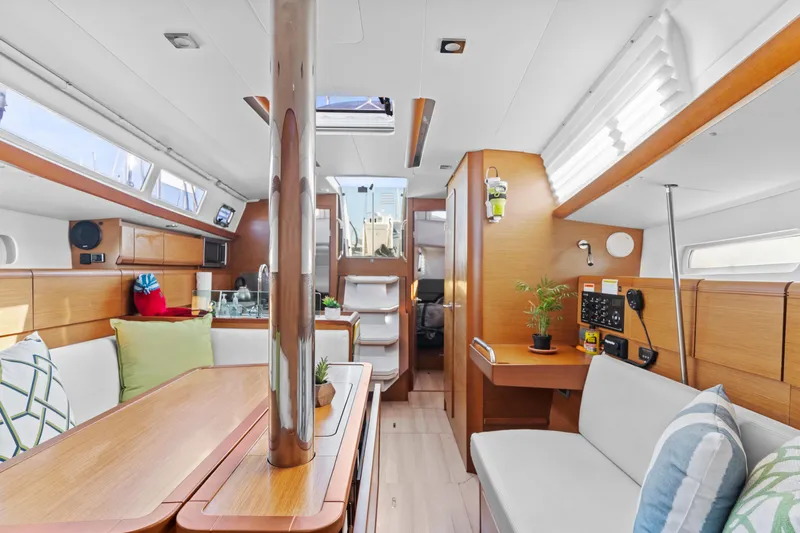 Deep Blue Yacht Photos Pics Interior of 2020 Jeanneau Sun Odyssey 389 sailboat, featuring modern wood finish and cozy seating.