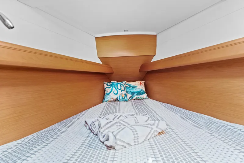 Deep Blue Yacht Photos Pics Cozy cabin interior of 2020 Jeanneau Sun Odyssey 389 sailboat with bedding and pillow.