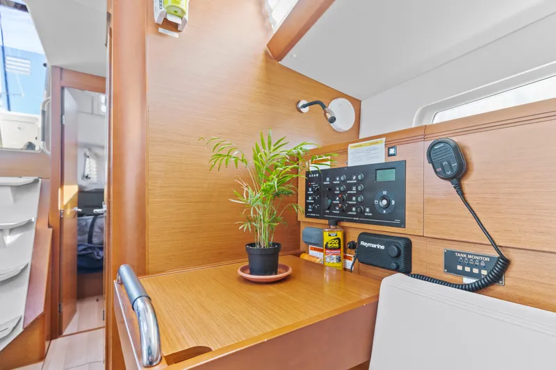 Deep Blue Yacht Photos Pics Jeanneau Sun Odyssey 389 interior, 2020 model, featuring navigation panel and potted plant.