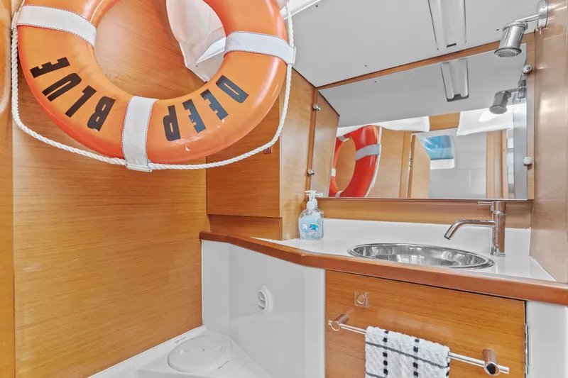 Deep Blue Yacht Photos Pics Bathroom interior of 2020 Jeanneau Sun Odyssey 389 yacht with life preserver.
