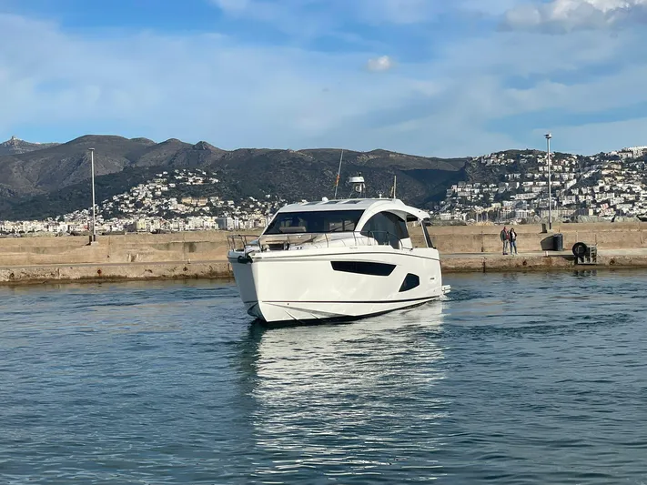 Sealine C530 Yacht Photos Pics 2017 Sealine C530 yacht in a harbor with mountainous backdrop and clear skies.