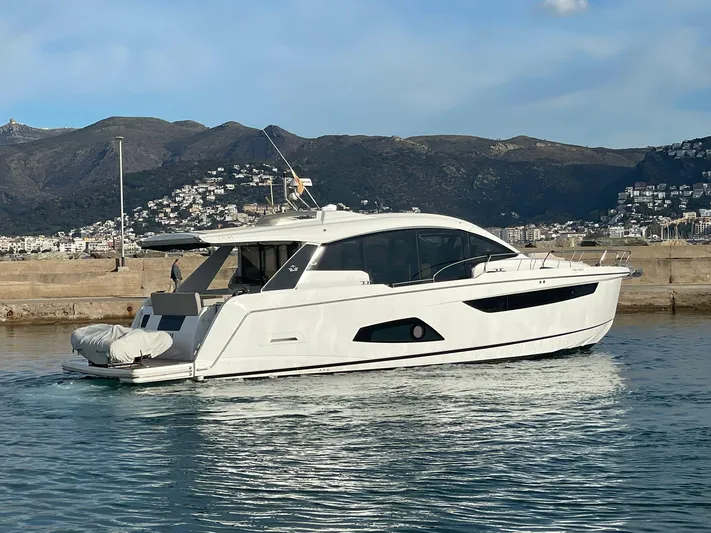 Sealine C530 Yacht Photos Pics 2017 Sealine C530 yacht docked in a scenic harbor with mountainous backdrop.