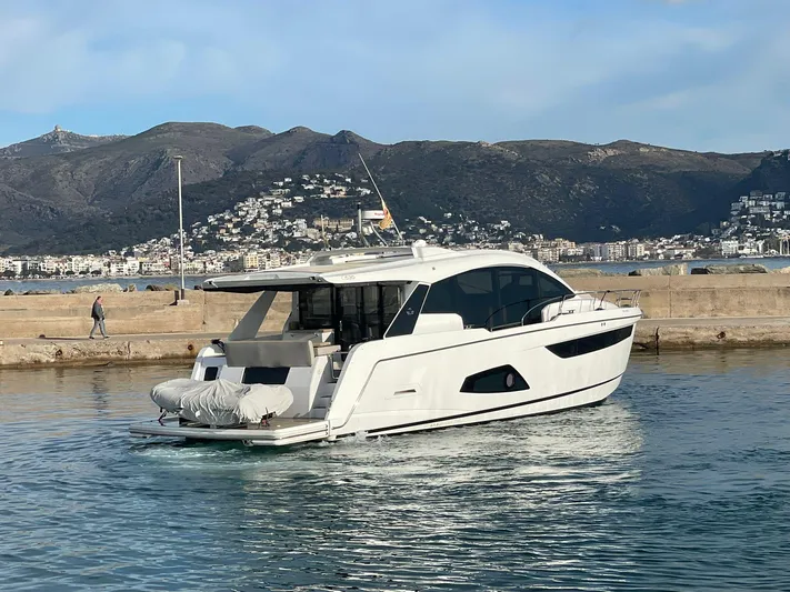 Sealine C530 Yacht Photos Pics Sealine C530 yacht from 2017 docked in a scenic harbor with mountainous backdrop.