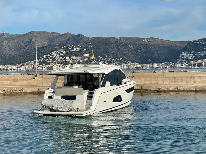 Sealine C530 Yacht Photos Pics Sealine C530 yacht from 2017 docked in a scenic harbor with mountainous backdrop.