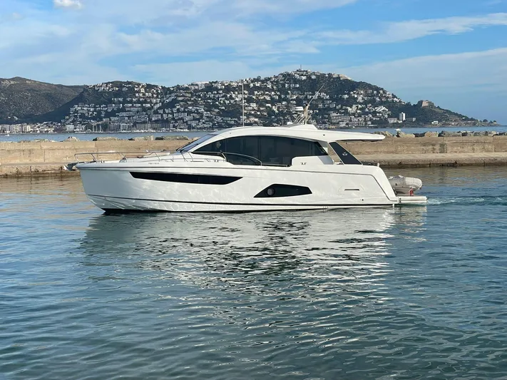 Sealine C530 Yacht Photos Pics 2017 Sealine C530 yacht cruising in a scenic coastal harbor.