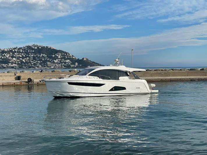 Sealine C530 Yacht Photos Pics 2017 Sealine C530 yacht docked in a scenic harbor with hills in the background.