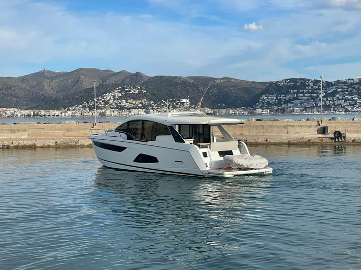 Sealine C530 Yacht Photos Pics Sealine C530 yacht from 2017 docked in a scenic harbor with mountains in the background.