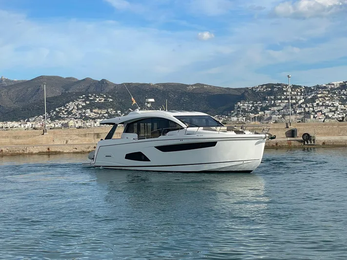 Sealine C530 Yacht Photos Pics Sealine C530 yacht from 2017 cruising in a scenic harbor with mountainous backdrop.