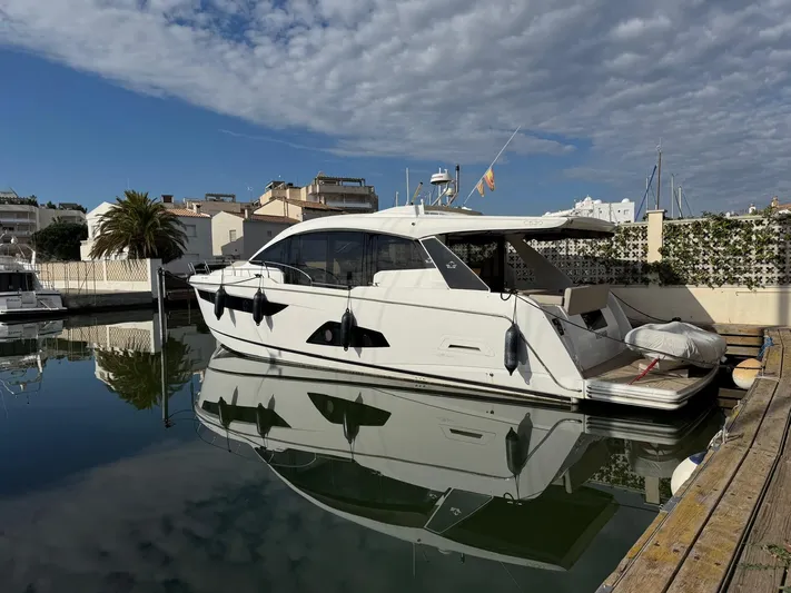 Sealine C530 Yacht Photos Pics 2017 Sealine C530 yacht docked in a marina, reflecting on calm water under a partly cloudy sky.