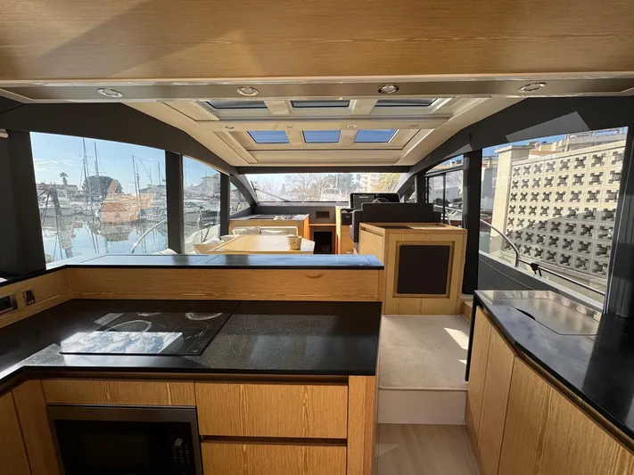 Sealine C530 Yacht Photos Pics Luxurious interior of 2017 Sealine C530 yacht with modern kitchen and panoramic windows.