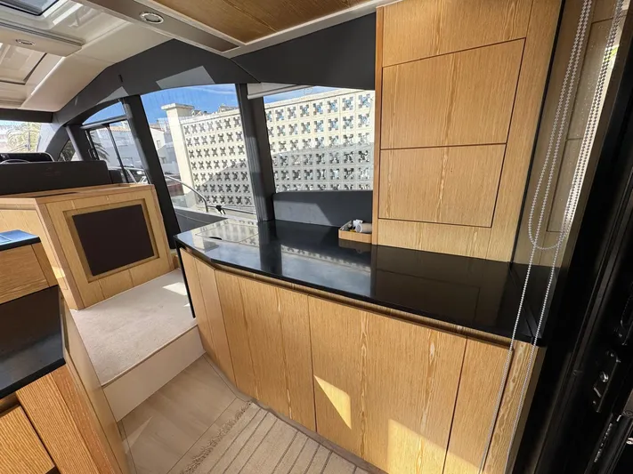 Sealine C530 Yacht Photos Pics Luxurious interior of 2017 Sealine C530 yacht with sleek wood cabinetry and modern design.