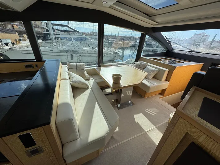 Sealine C530 Yacht Photos Pics Luxurious interior of 2017 Sealine C530 yacht with elegant seating and panoramic windows.